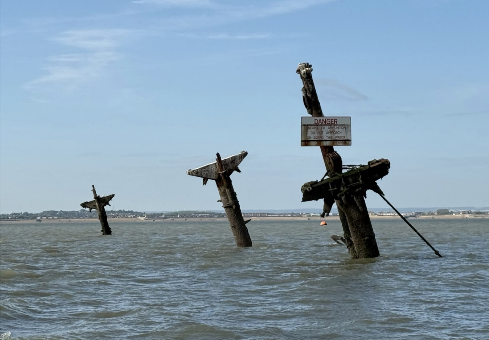The three masts of SS Richard Montgomery visible above the Thames Estuary at low tide