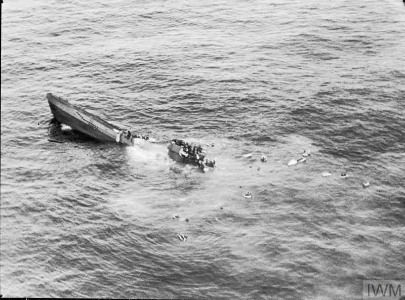 The crew of U-625 taking to their dinghies as the submarine sinks by the stern